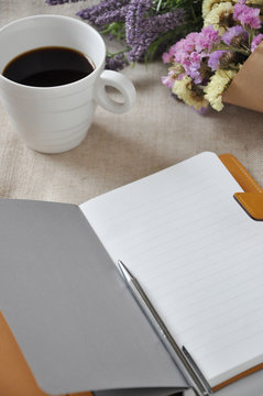 Blank Page Notebook with Pen and Coffee Cup on Background