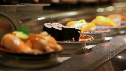 Conveyor belt sushi or rotating sushi in a Japanese restaurant inside a food court restaurant in Tokyo, Japan