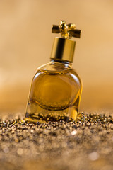 Obraz na płótnie Canvas perfume in beautiful bottle on beads. Still life (gold tone)