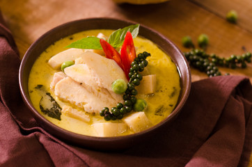 Chicken mussaman curry in bowl vegetables on wooden background