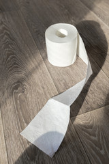 Toilet paper on wood background