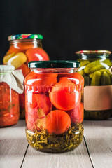 Preserved vegetables on wooden background