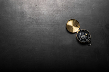 Compass on black board background