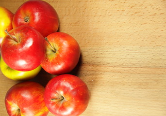 Red apples on wooden background
