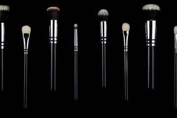Makeup brushes on black background
