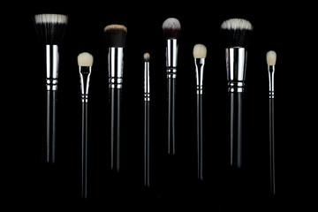 Makeup brushes on black background