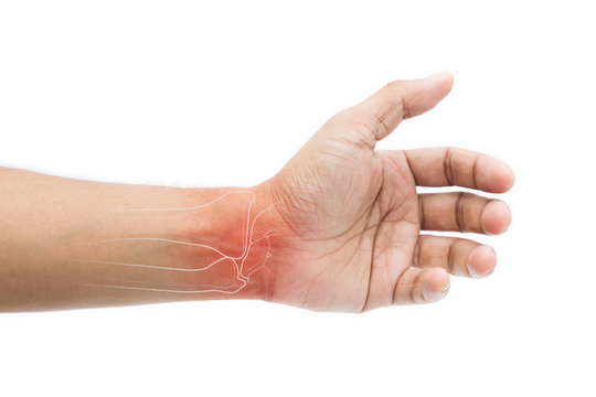Man massaging painful wrist on a white background. Pain concept