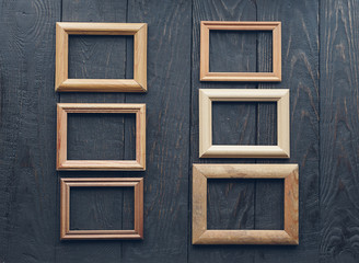 old frames on wooden wall