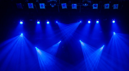 Blue rays of light through the smoke on stage. Theater performance. Lighting equipment