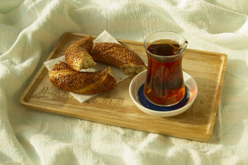 Bagel and cup of turkish tea on the wood tray with Istanbul pict