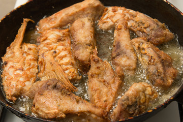 fish is fried in a pan