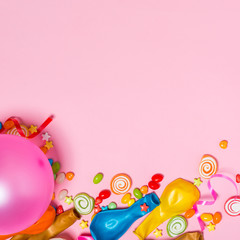 Celebration Flat lay. Candy with colorful party items on pink ba