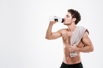 Sportsman standing with towel holding bottle of water