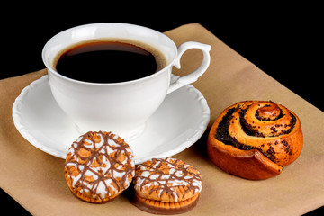 Bun, chocolate chip cookies and a cup of coffee on a white background