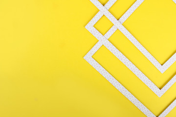 Geometric abstraction on a yellow background.