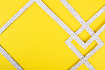 Geometric abstraction on a yellow background.