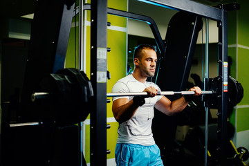 Fototapeta na wymiar handsome fitness man weightlifting workout in gym
