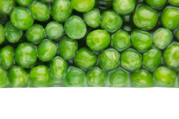 Border of wet fresh  green peas in water closeup on white background. Isolated. Healthy vitamin food.