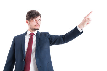 Portrait of business man showing something with index finger