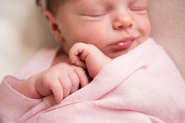 Newborn baby girl asleep on a blanket. Selective focus