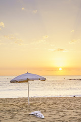 Beach umbrella at sunrise