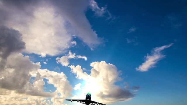 Airplane fly by sunny day blue sky. Video loop