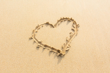 Draw heart on beach. valentine day