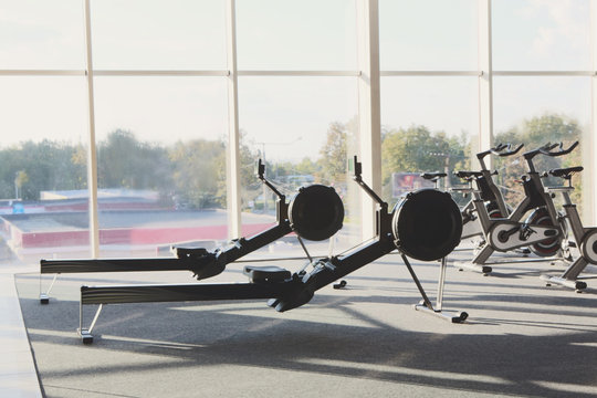 Modern gym interior with equipment, fitness leg exercise machine