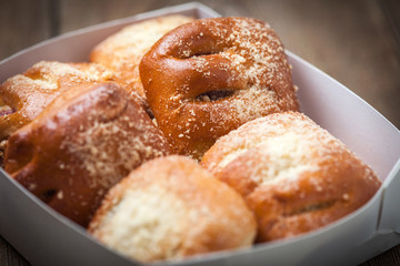 Buns with berries on a wooden table.