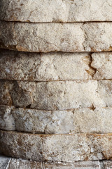 Fresh baked bread and sliced bread on rustic wooden table