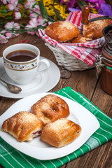 Buns with berries on a wooden table.
