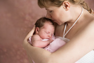 Newborn baby girl in her mother's hands