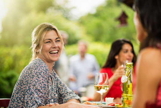Group of friends having lunch, focus on a woman