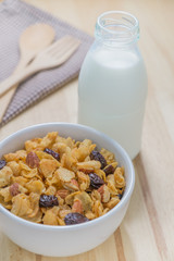 Corn flakes nutrition cereal and milk on wooden surface for healthy breakfast