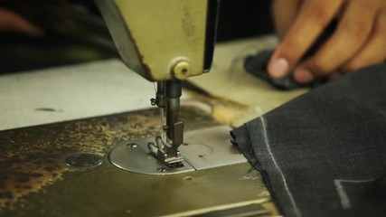 Sewing machine making stitches on a bespoke tailored suit
