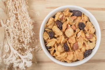 Corn flakes nutrition cereal and milk on wooden surface for healthy breakfast, Top view