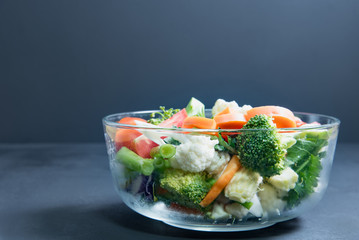 healthy foods are on the table, Fresh vegetable salad in a glass