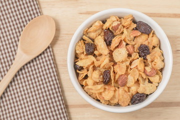 Corn flakes nutrition cereal and milk on wooden surface for healthy breakfast, Top view