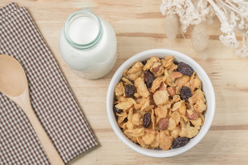 Corn flakes nutrition cereal and milk on wooden surface for healthy breakfast, Top view