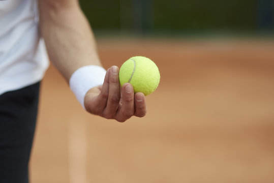 Player is holding a tennis ball.