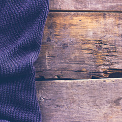 knitted plaid, sweater on old wooden boards