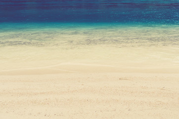 Soft wave of blue ocean on sandy beach. Background.