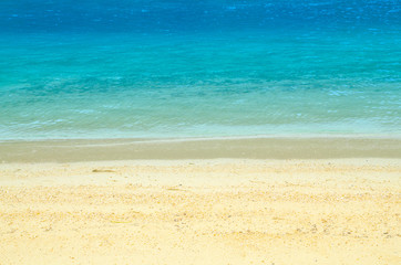 Soft wave of blue ocean on sandy beach. Background.