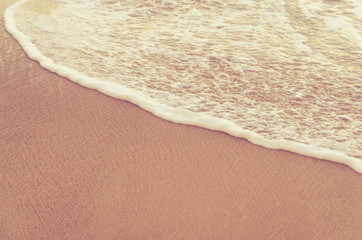 Soft wave of blue ocean on sandy beach. Background.