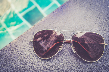 Brown funky sun glasses near swimming pool.Outdoor shot using na