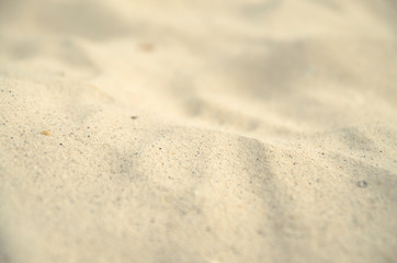Fototapeta na wymiar Close up sand with blurred sea sky background, summer day, copy
