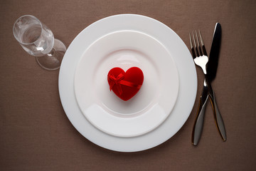 Red heart on a plate for romantic date on Valentines day.