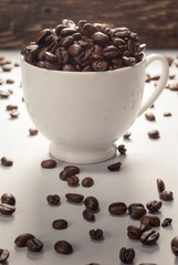 Coffebeans on Neutral Gray Background. Dark Roast Coffee. White