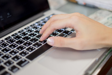 Hand of Man typing on laptop keyboard