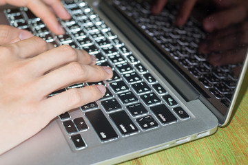 Hand of Person typing on laptop keyboard